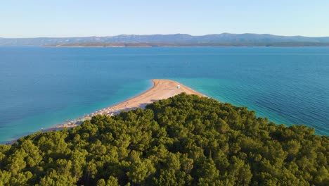 Drone-flight-over-the-coastal-strip,-trees-and-the-beach-in-the-resort-town-of-Croatia-on-the-shores-of-the-Adriatic-Sea