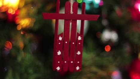 Red-snow-sled-hanging,-made-of-popsicle-sticks