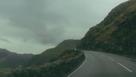 POV-on-the-road-through-a-mountain-pass,-Snowdonia,-Wales,-UK
