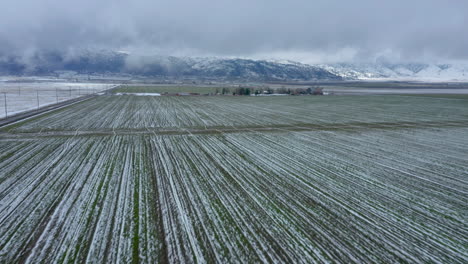 Flying-toward-a-wintery,-snowy-farm-in-Tehachapi,-CA