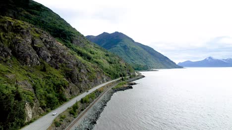 Cars-driving-road-along-Turnagain-arm-coast-outside-of-Anchorage-Alaska