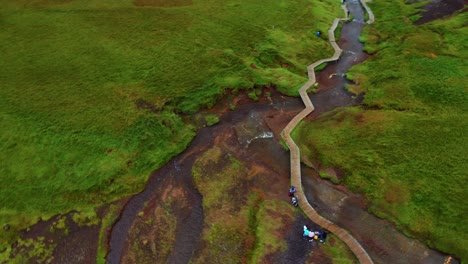Touristen-Im-Reykjadakur-Tal-In-Island,-Berühmt-Für-Seinen-Heißen-Fluss-Mit-Holzsteg