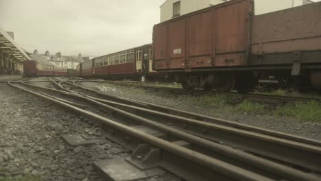 Ffestiniog-Railway-Track-leads-the-eye-to-a-stream-train-cross-in-the-background