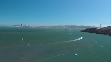 Expansive-view-of-San-Francisco-and-Golden-Gate-Bridge-from-Sausalito-Harbor-filled-with-boats