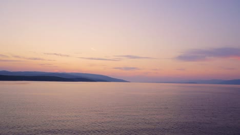 Sunrise,-sunset-over-open-Adriatic-sea-with-coast-visible-in-the-background