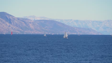 Beautiful-view-of-sailboats-in-Adriatic-sea-with-mountainous-coast-in-the-background