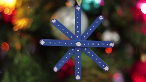 Blue-snowflake-hanging,-made-of-popsicle-sticks