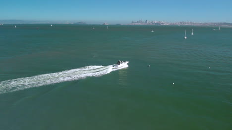 Kreisen-Um-Ein-Boot-Im-Hafen-Von-Sausalito,-Das-San-Francisco-Und-Die-Golden-Gate-Bridge-Im-Hintergrund-Enthüllt