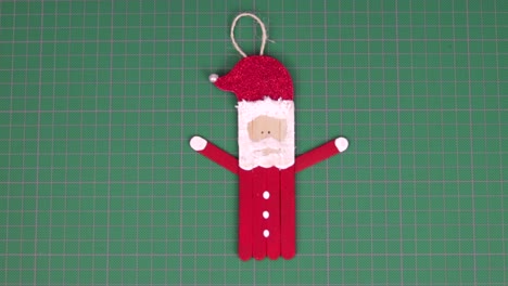 Figure-of-santa-claus-made-with-popsicle-sticks-on-a-cutting-mat