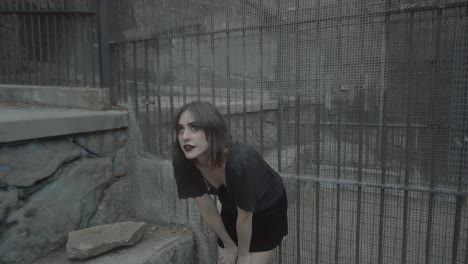 Slow-motion-clip-of-a-gothic-woman-model-in-a-jail