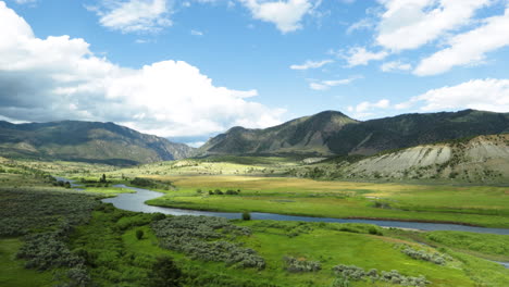 Winding-through-a-lush-green-valley-in-Colorado-on-a-train