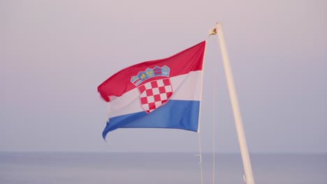 Static-aerial-shot-of-Croatian-flag-in-wind-on-the-sea-ferry