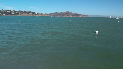 Drone-flying-low-along-the-water-of-Sausalito-Harbor-across-the-bay-from-San-Francisco