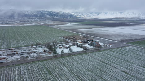 Rising-over-a-wintery,-snowy-farm-in-Tehachapi,-CA