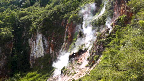 Toxic-Sulfur-Steam-rising-up-from-geothermal-springs-along-green-mountains-in-nature