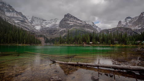 Timelapse,-Dramatic-Clouds-Moving-Above-Snow-Capped-Peaks-and-Crystal-Clear-Lake-Water