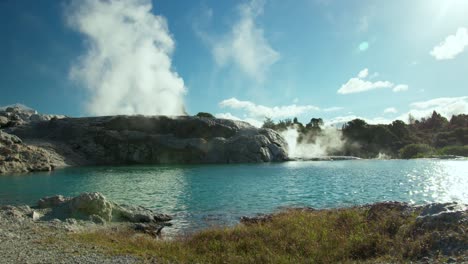 Geothermal-Valley-Te-Puia-with-geyser-pool-on-sunny-day,-Whakarewarewa