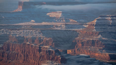 Time-Lapse,-Dead-Horse-Point-State-Park-in-Winter-Season,-Mist-and-Clouds-Above-Sandstone-Cliffs-and-Canyon
