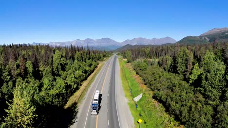 Aerial-view-of-Big-truck-driving-down-road-in-Alaska-Interior