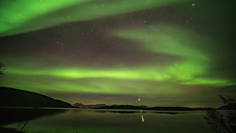 Northern-lights-and-the-Moon-on-the-starry-sky-reflected-in-the-fjord