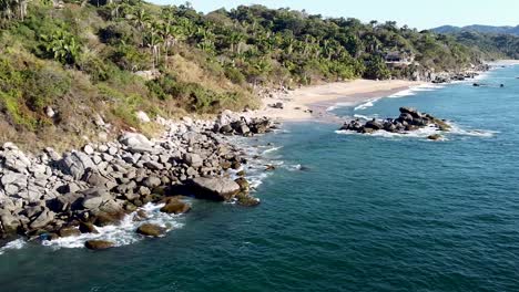 An-aerial-drone-clip-of-wild-lush-paradise-beach-in-Sayulita,-Mexico