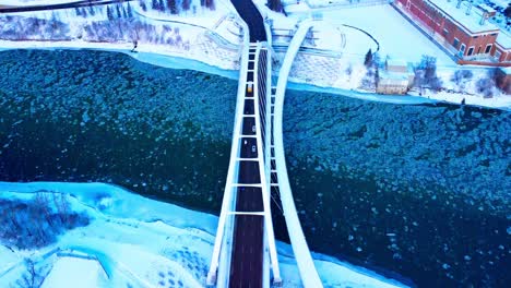 school-bus-crossing-Walter-Dale-Bridge-aerial-flyover-panoramic-pan-out-dolly-roll-as-skyline-reveals-the-downtown-Edmonton-City-skyscrapers-in-the-capital-of-Alberta-Canada-winter-snow-covered-2-2