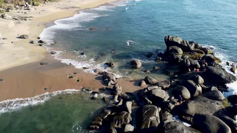 An-aerial-drone-clip-of-wild-tropical-paradise-beach,-Playa-Carricitos-in-Sayulita,-Nayarit,-Mexico