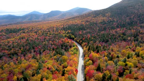 Aerial-View-of-road-through-mountains-with-autumn-changing-leaves