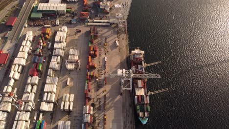 Aerial-view-above-Vigo-cargo-container-ship-loading-and-unloading-at-port-shipyard-terminal