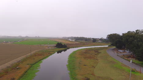 Drone-flyover-on-irrigation-canal-to-nearby-plantations