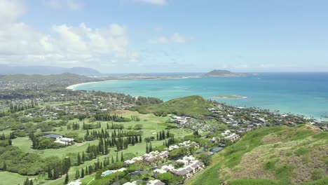 Golf-course-on-a-tropical-island-with-ocean-and-mountains-and-beach-in-view