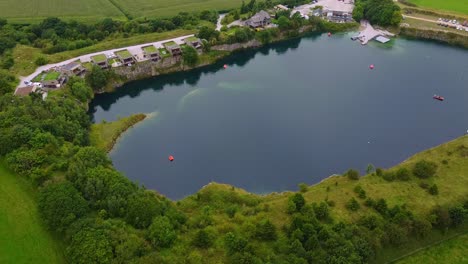 Panning-drone-shot-of-diving-reservoir-with-eco-homes