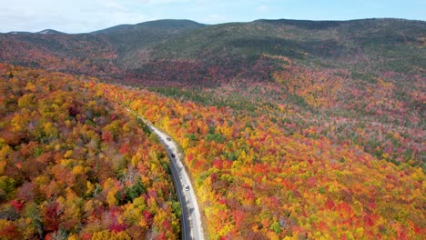 Cars-driving-Mountain-pass-in-New-England-during-fall-with-changing-leaves