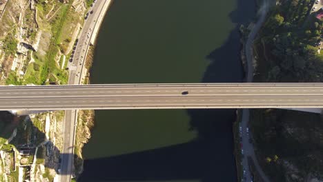 Aerial-Birdseye-view-above-long-straight-Porto-bridge-crossing-Douro-river-looking-down