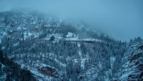 Time-Lapse,-Freezing-Winter-Scenery,-Fog-Above-Snow-Capped-Hills-and-Conifer-Forest