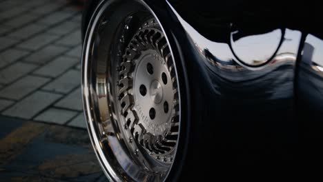View-of-the-rear-axle-with-a-silver-shiny-wheel-disk-of-a-dark-new-luxury-car