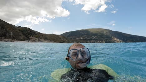 Close-Up-Of-Snorkeler-Equipped-With-Diving-Mask-And-Breathing-Tube-While-Swimming-In-The-Sea
