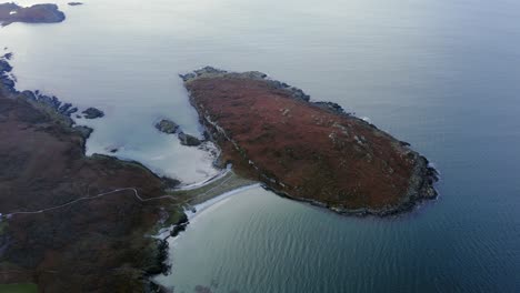 AERIAL---Tombolo-of-a-small-island-and-the-Isle-of-Gigha,-Kintyre,-Scotland