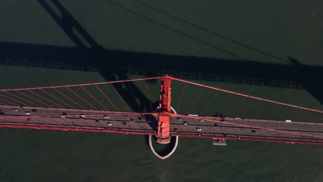 Aerial-view-over-traffic-on-the-Golden-gate-bridge,-in-SF,-USA---rotating,-tilt,-drone-shot
