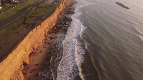 Slow-motion-cliffs-at-beautiful-sunset-in-a-panoramic-view-in-Acantilados-de-Mar-del-Plata,-Argentina