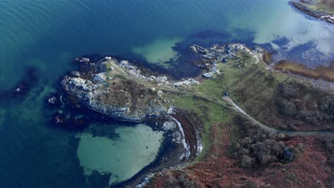AERIAL---Top-down-view-of-turquoise-waters-of-the-Isle-of-Gigha,-Kintyre,-Scotland