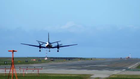 A-Turboprop-Propeller-Airplane-Touching-Down-on-the-Runway,-Rear-Shot