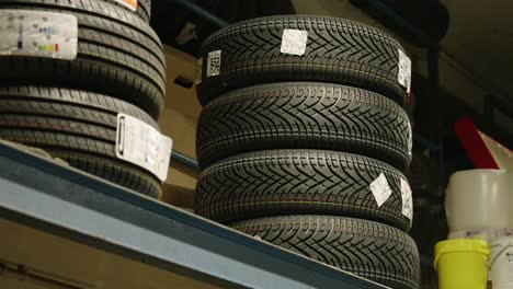 Piles-of-tires-on-a-shelf-in-a-garage