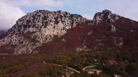 Aerial-panning-view-of-red-vegetation-at-the-foot-of-the-mountain-of-Pietraroja