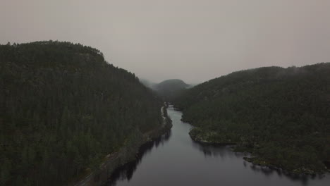 Drone-shot-flying-through-mist-and-fog-in-a-mountain-valley,-Norway
