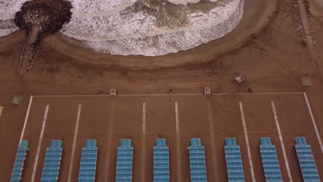 Ascending-aerial-view-of-tents-at-beach-resort,-Mar-del-Plata