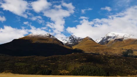 Epic-Yellow-covered-Mountains-with-Snowy-Peak-in-Fiordland-national-park-during-Autumn-Season