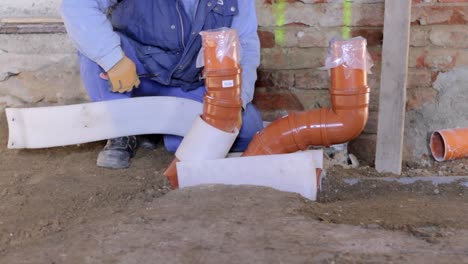 builder-fixing-sewage-pipe-with-masking-tape-stock-video