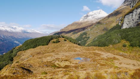 Panorama-view-of-beautiful-mountains-covered-with-snow-on-peak-during-sunny-day-Fiordland-National-park
