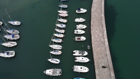 Aerial-overhead-shot-of-sailing-boats-moored-at-the-Cobb-Lyme-Regis-Dorset-England